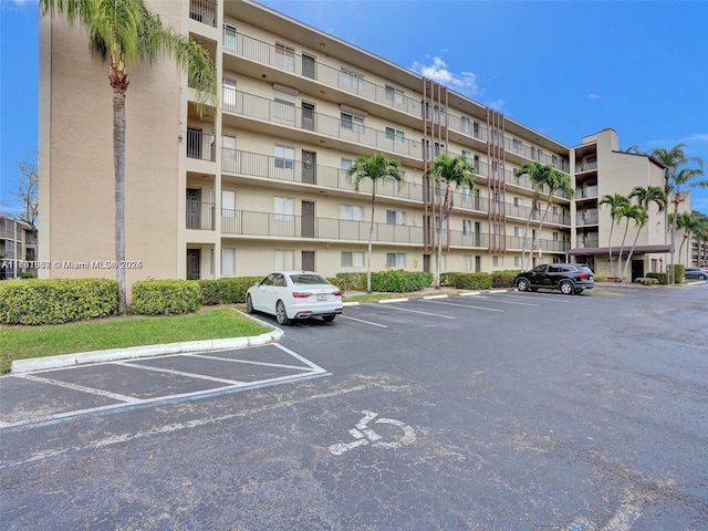 view of building exterior featuring uncovered parking