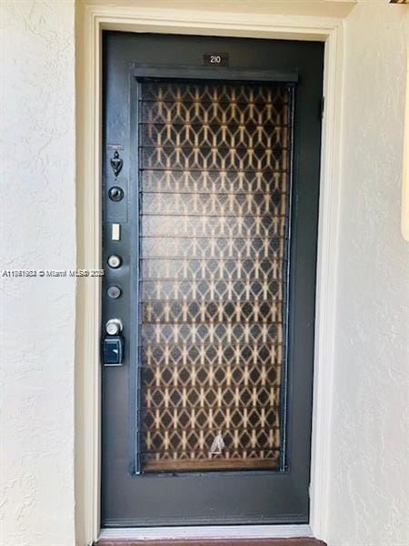 property entrance with stucco siding