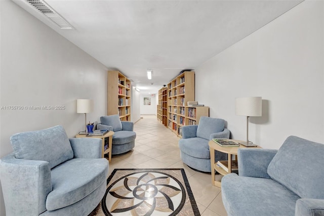 living room featuring light tile patterned floors and visible vents