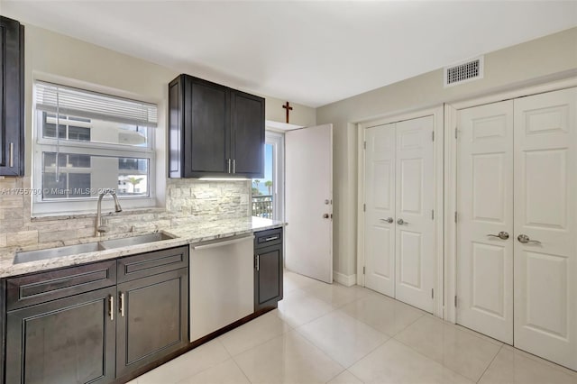 kitchen featuring visible vents, a sink, light tile patterned floors, decorative backsplash, and dishwasher