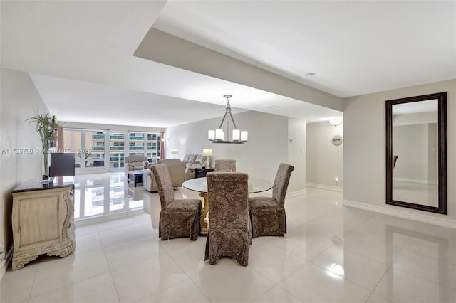 dining space with light tile patterned floors, baseboards, and a notable chandelier