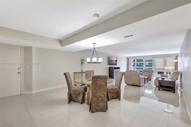 dining room featuring light tile patterned floors, baseboards, and visible vents