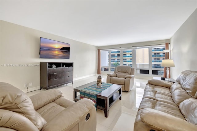 living area with light tile patterned floors and baseboards