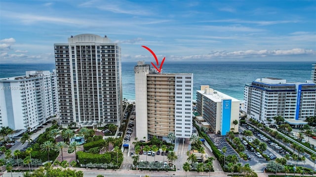 birds eye view of property featuring a view of city and a water view