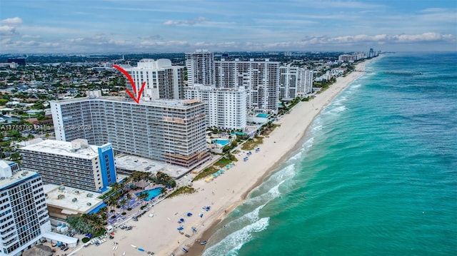 birds eye view of property with a water view, a city view, and a view of the beach