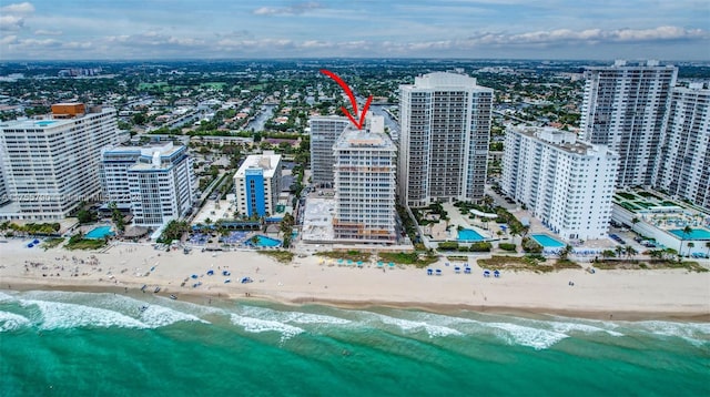 birds eye view of property featuring a view of city and a beach view