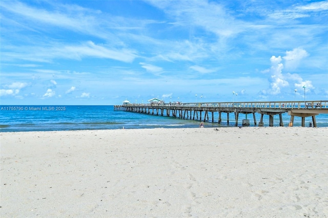 view of water feature featuring a pier and a view of the beach