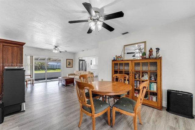 dining space featuring ceiling fan, visible vents, and light wood-style flooring