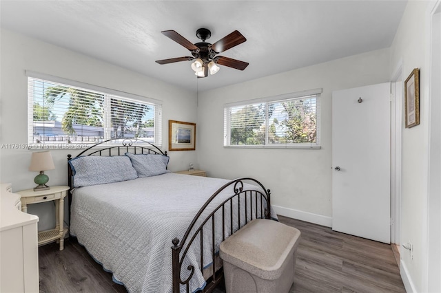 bedroom with ceiling fan, baseboards, and wood finished floors