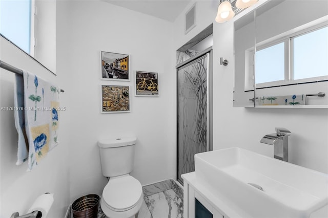 bathroom with vanity, visible vents, a shower stall, toilet, and marble finish floor