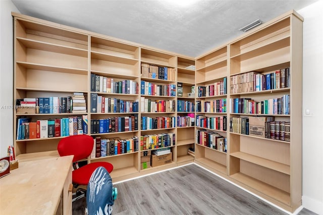 sitting room with visible vents and wood finished floors