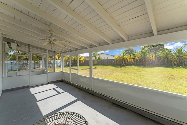 unfurnished sunroom featuring vaulted ceiling with beams and a ceiling fan