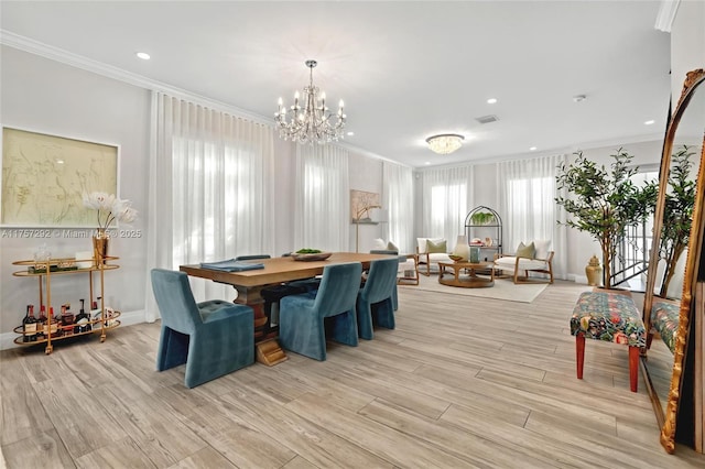 dining space with crown molding, recessed lighting, visible vents, and light wood finished floors