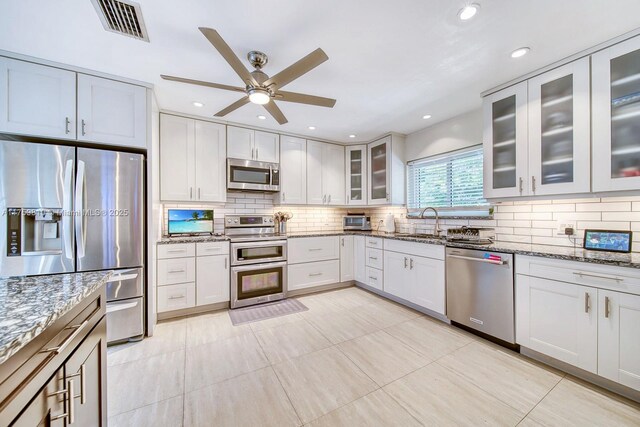 13700 SW 74th Ct, Palmetto Bay, FL 33158 - kitchen with stainless steel appliances, a ceiling fan, stone countertops, tasteful backsplash, and recessed lighting