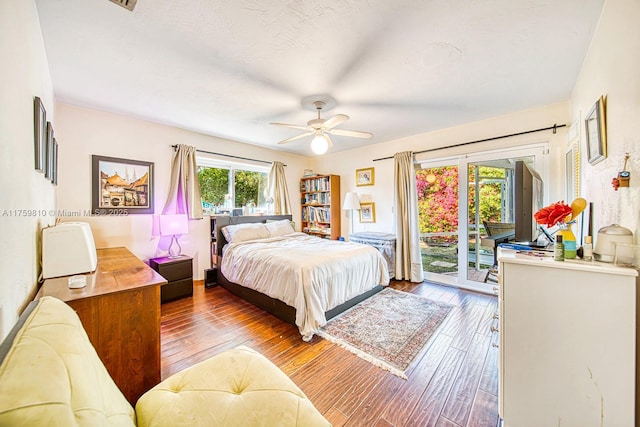 bedroom featuring access to exterior, a textured ceiling, ceiling fan, and hardwood / wood-style flooring