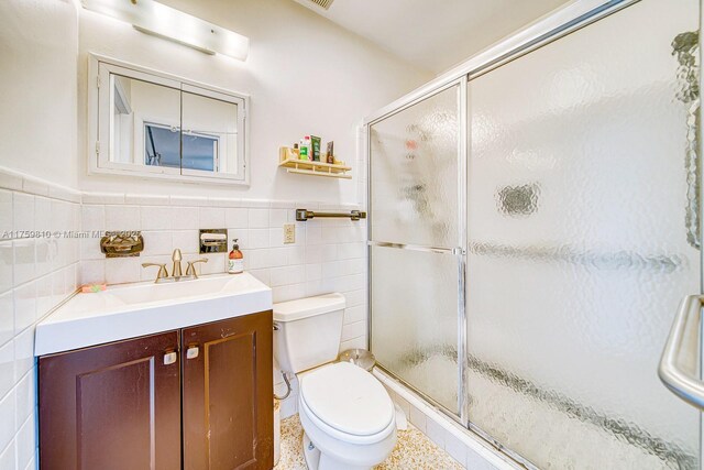 13700 SW 74th Ct, Palmetto Bay, FL 33158 - full bathroom featuring tile walls, vanity, a stall shower, and wainscoting