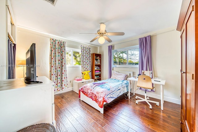 bedroom featuring ceiling fan, baseboards, and hardwood / wood-style floors