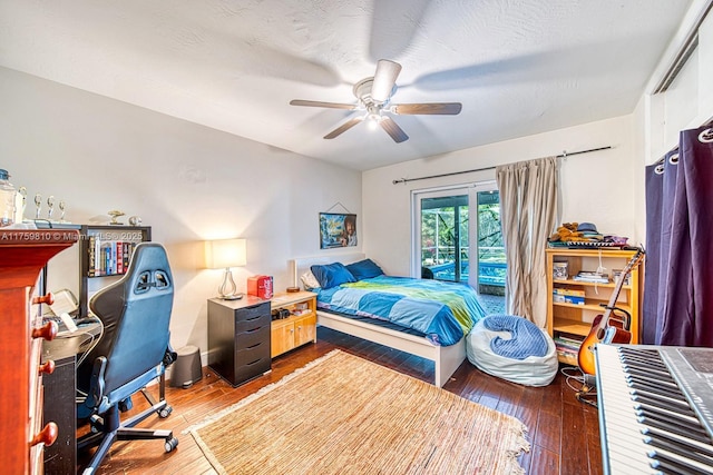 bedroom featuring wood-type flooring, a textured ceiling, ceiling fan, and access to outside