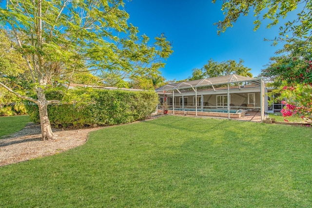 view of yard featuring a patio area, glass enclosure, and an outdoor pool