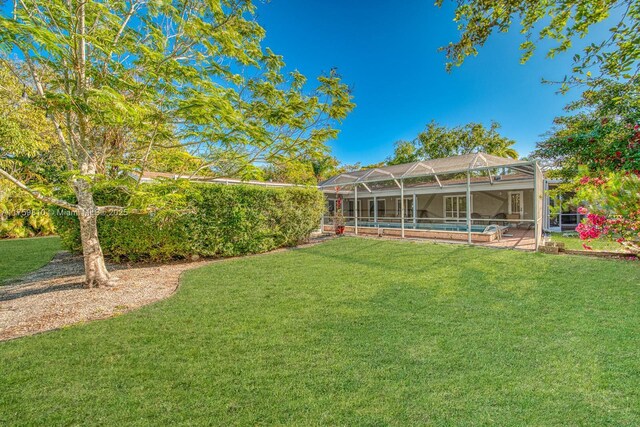 13700 SW 74th Ct, Palmetto Bay, FL 33158 - view of green lawn with an outdoor pool and a lanai