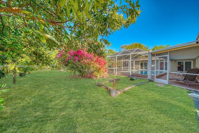 view of yard featuring a pool, glass enclosure, and a patio