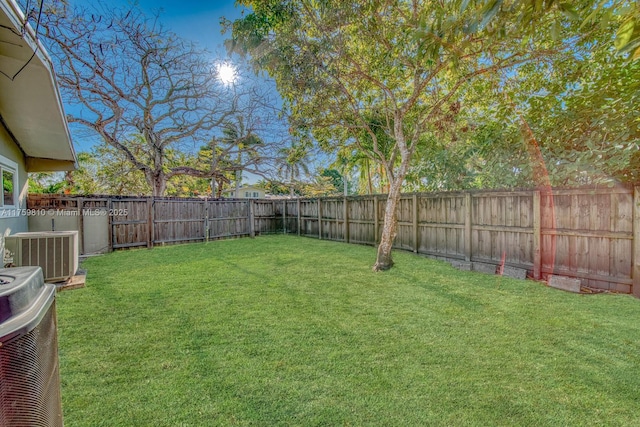 view of yard with cooling unit and a fenced backyard