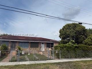 view of front of property featuring a fenced front yard and a gate