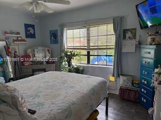 bedroom with dark wood-type flooring and ceiling fan