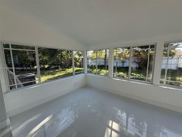 unfurnished sunroom with plenty of natural light and vaulted ceiling