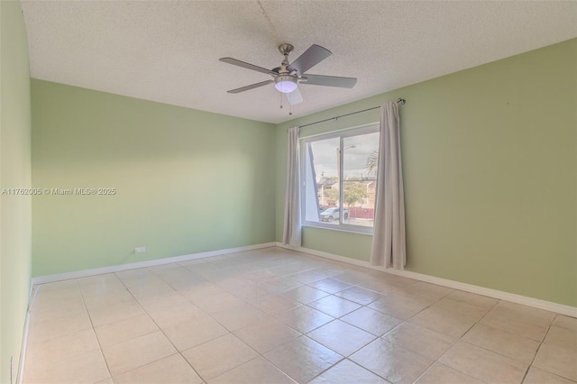 unfurnished room with light tile patterned floors, baseboards, a textured ceiling, and a ceiling fan