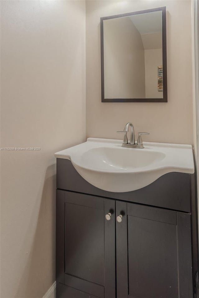 bathroom featuring baseboards and vanity