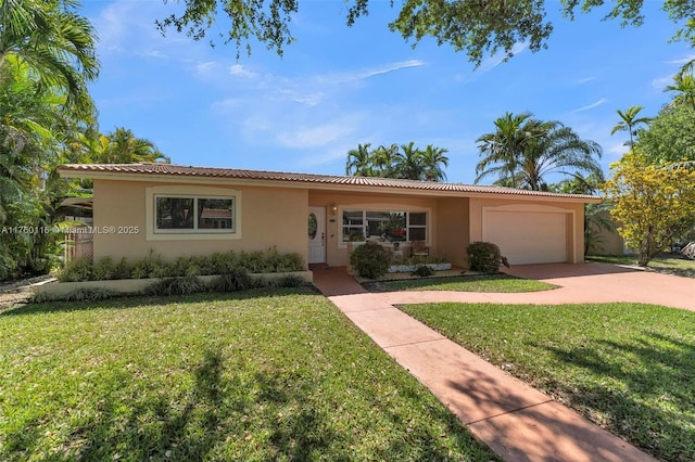 view of front of house with a front yard, an attached garage, and stucco siding