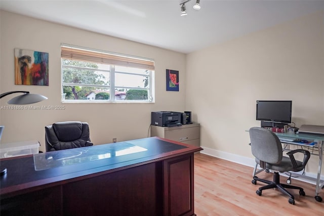 office area with rail lighting, baseboards, and light wood-style floors