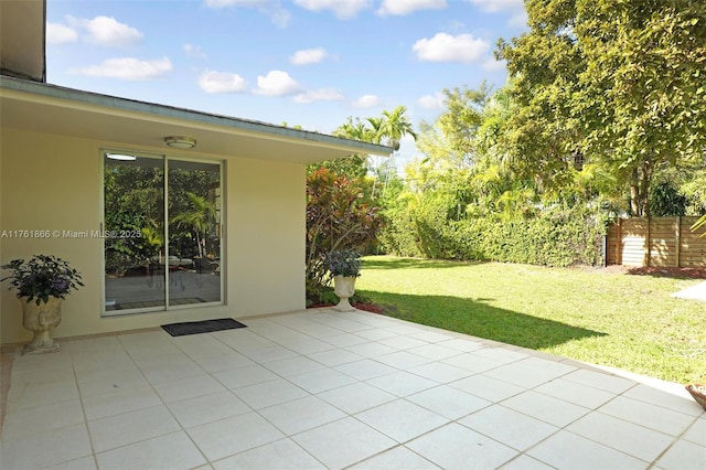 view of patio featuring fence