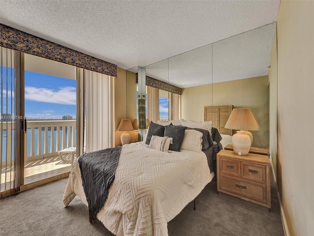 1000 W Island Blvd Unit 2606, Aventura, FL 33160 - bedroom featuring carpet flooring, multiple windows, a textured ceiling, and access to exterior