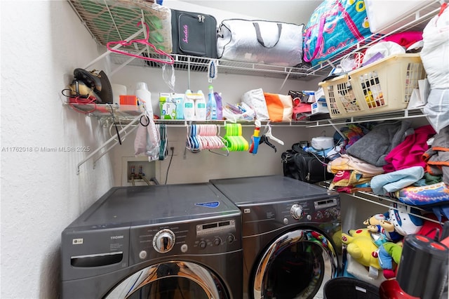 washroom with washer and clothes dryer and laundry area