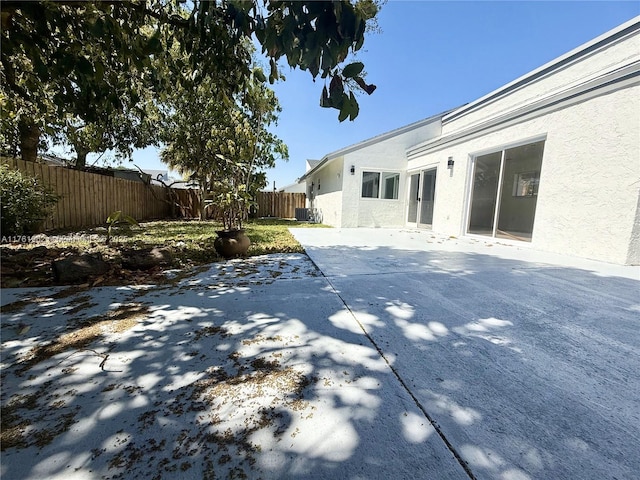 view of patio featuring central air condition unit and a fenced backyard