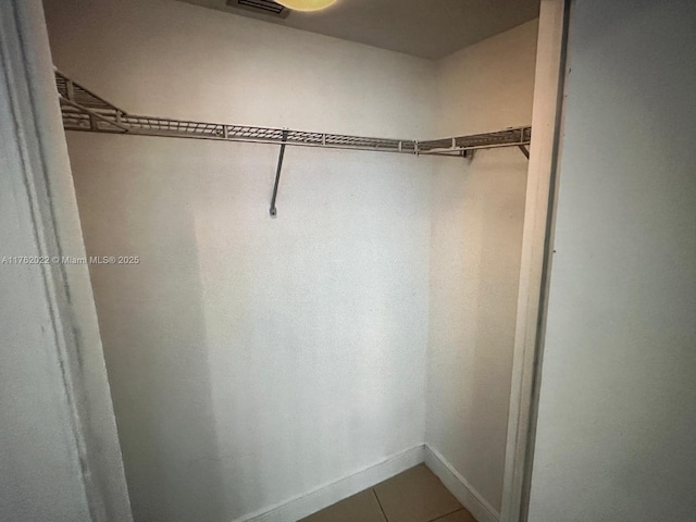 spacious closet featuring tile patterned flooring