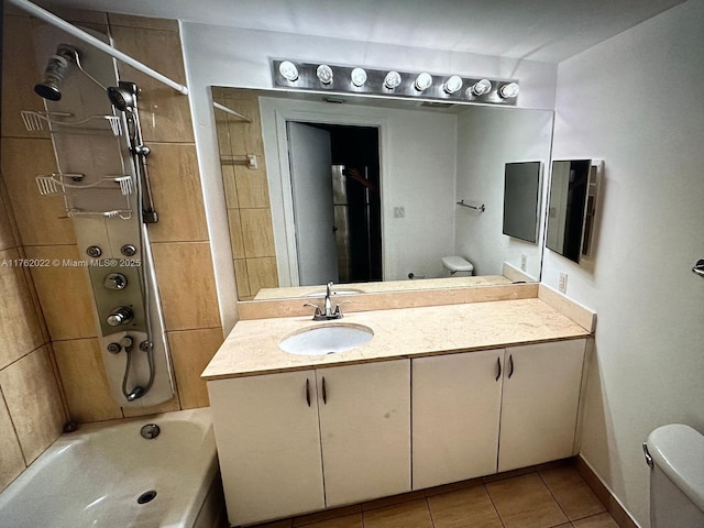 bathroom with vanity, tile patterned floors, toilet, and washtub / shower combination