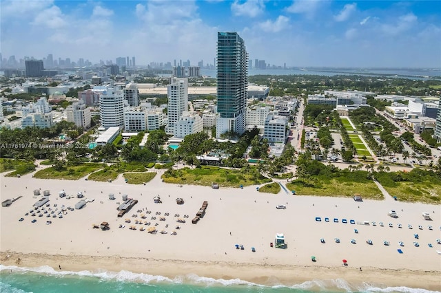 birds eye view of property with a view of city, a water view, and a beach view