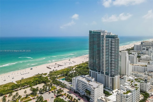 birds eye view of property with a city view, a beach view, and a water view