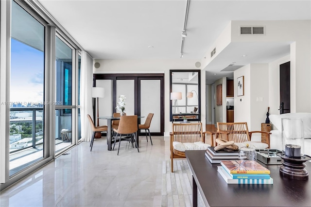 dining space featuring visible vents, french doors, track lighting, and expansive windows