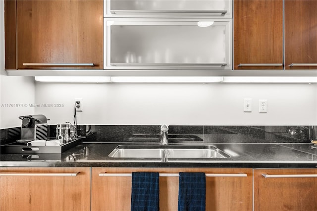 kitchen with dark countertops and a sink