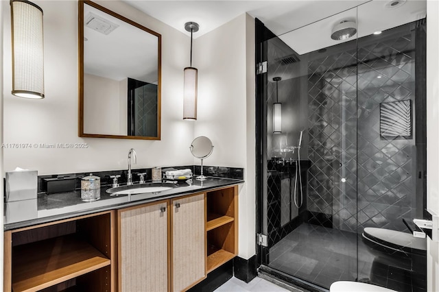 bathroom featuring visible vents, toilet, a stall shower, and vanity