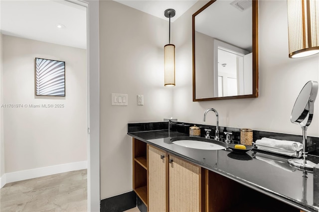 bathroom featuring visible vents, vanity, and baseboards