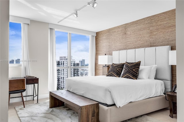 bedroom featuring a city view and track lighting