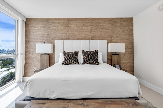 bedroom featuring a city view and baseboards