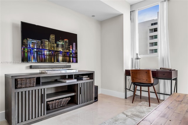 bar featuring baseboards and finished concrete floors