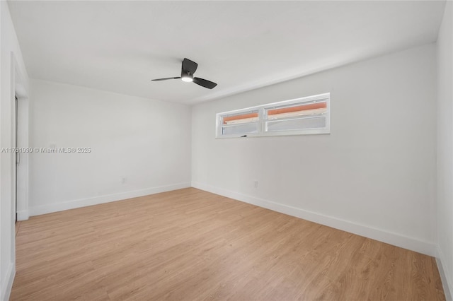 empty room with baseboards, light wood-style floors, and a ceiling fan