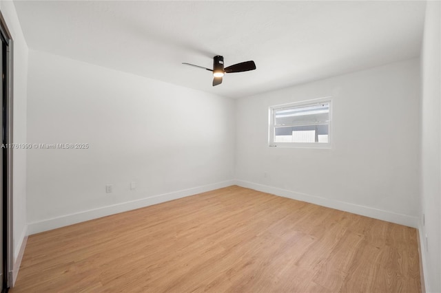 unfurnished room with light wood-style floors, baseboards, and ceiling fan